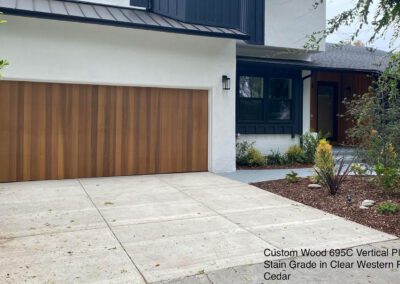 Modern home with stylish cedar garage doors, adding a warm touch to the contemporary design.