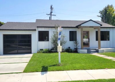 This image shows a modern home with sleek garage doors and a well-maintained exterior