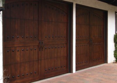 ornate wooden garage doors that add a touch of sophistication to the facade.